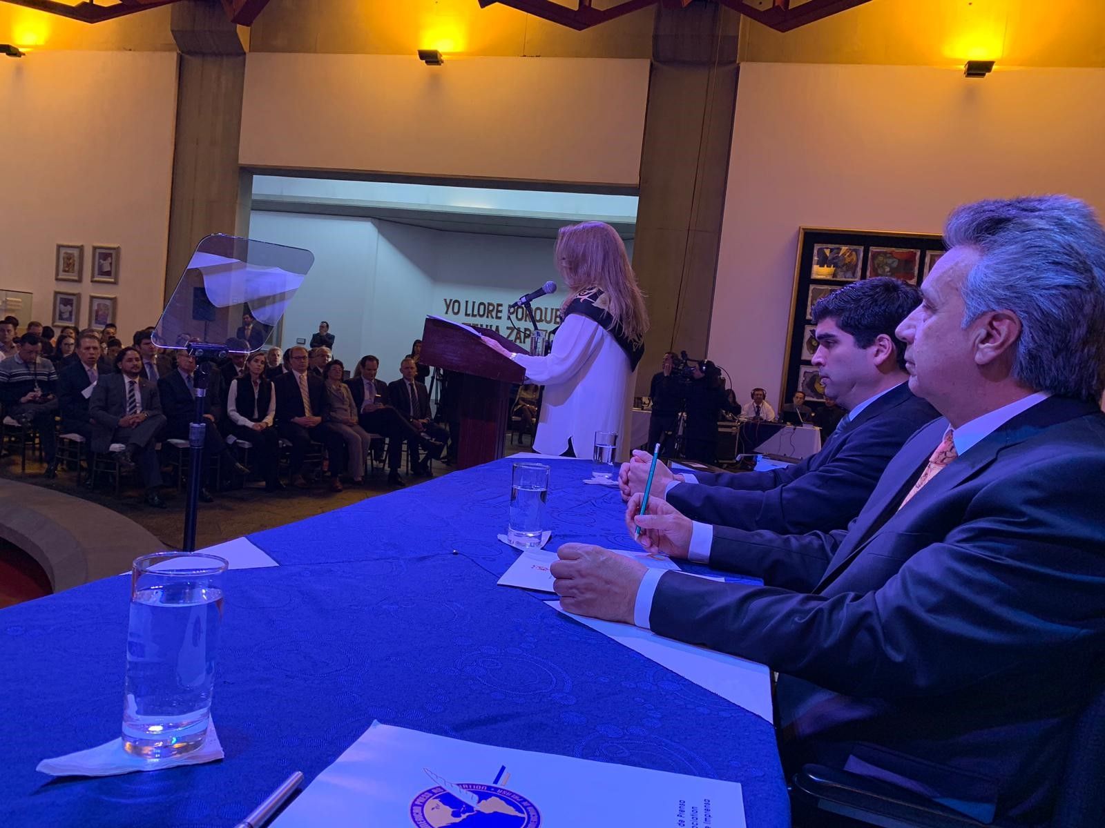 La presidenta de la SIP, María Elvira Domínguez, dirige unas palabras a los presentes. En la mesa, a la derecha, el presidente Lenín Moreno y a su lado el vicepresidente&nbsp;Otto Sonneholzner. (Foto RT/SIP)